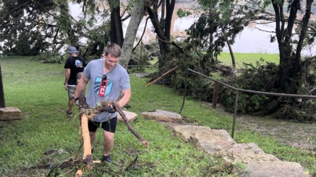 Cleaning up debris following flooding at Tree Top Cabins.